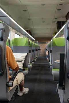 A half-empty passenger car of a high-speed train. Stock Photos
