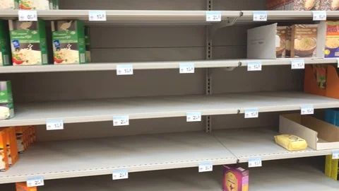 Half empty rice, pasta shelves in a super market. People are buying a lot Stock Footage 126587428