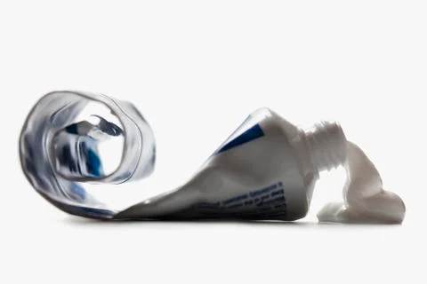 Half empty toothpaste tube spilling Stock Photos