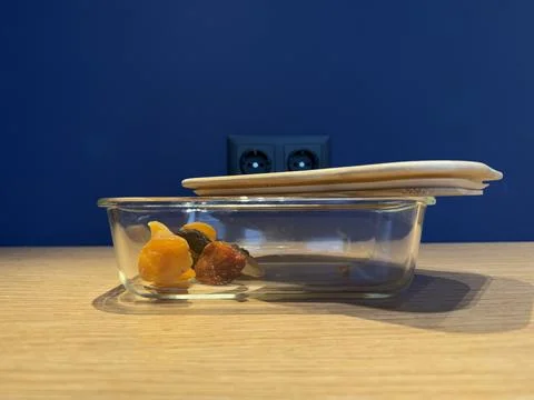 Half empty transparent container with dried fruits Stock Photos