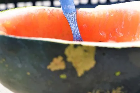 Half empty watermelon with spoon Stock Photos