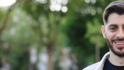 Half face of bearded man with beautiful brown eye while standing outdoors Stock Footage 200201870