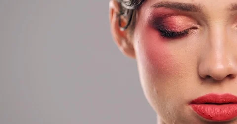 Half face of a model with bright eye makeup looking to the camera.  Attractiv Stock Footage 125292915