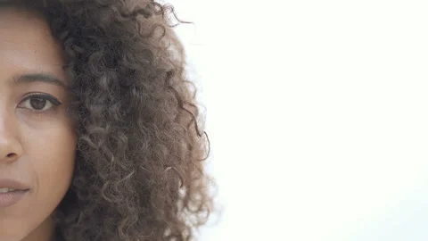 Half face portrait of afro american woman outdoors. Looking at the camera. Stock Footage 107310538
