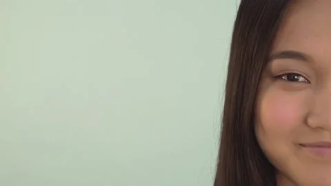 Half face portrait close-up. lovely asian girl smiles broadly. 4K Stock Footage 133510013