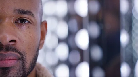 Half face portrait of handsome black male looking to camera Stock Footage 100343321