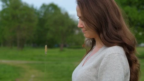 Half face portrait of romantic in summer park Stock Footage 90370991