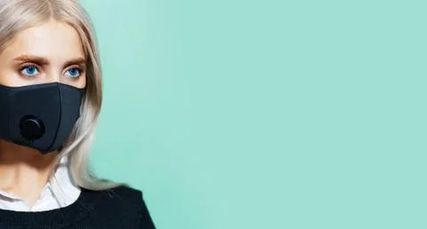 Half face studio portrait of young blonde girl with blue eyes and face mask.  Stock Photos