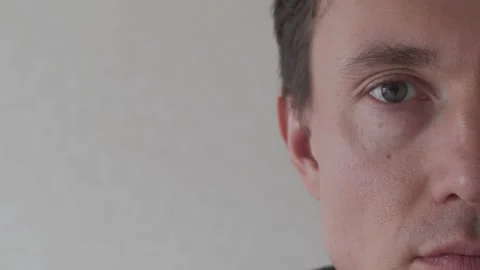 Half Face of Young Man Looking into Camera Stock Footage 172535671