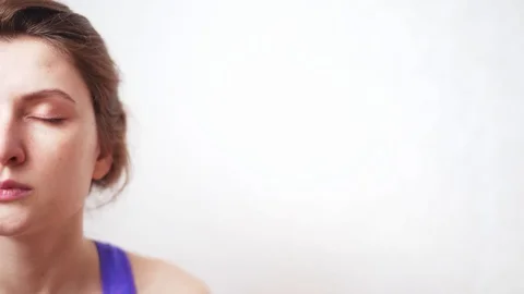 Half female face close-up, copyspace. Breathing exercises, concentration and Stock Footage 128975542