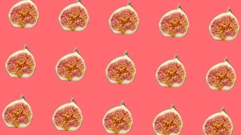 A half of fig in animated grid seamless loop pattern on a coral background Stock Footage 222326744