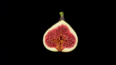 Half a fig isolated on black background, rotate. 4K UHD video Stock Footage 161326192