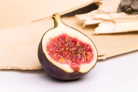 Half of fig on nature background Stock Photos
