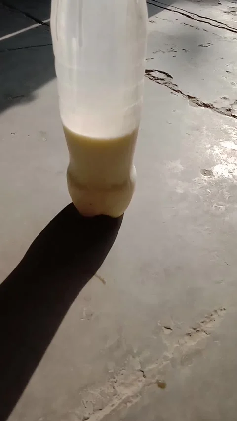 Half filled bottle with white milk Stock Footage 322039876