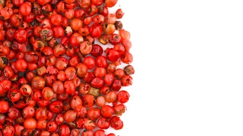 Half frame of circle shaped pink peppercorn pile rotating on the turntable. Stock Footage 96985946