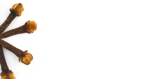 Half frame of star shaped dried cloves pile. Vertically rotating. Isolated Stock Footage 96483277
