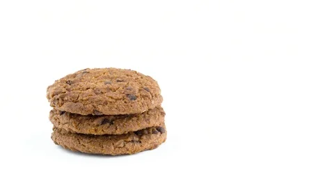 Half frame of a three soft and chewy chocolate chip oatmeal cookies rotating Stock Footage 94898306