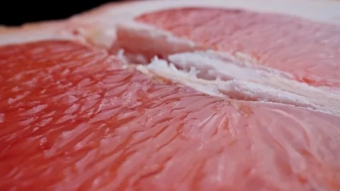 Half of fresh grapefruit rotating at black background. Organic healthy food Видео 329436951