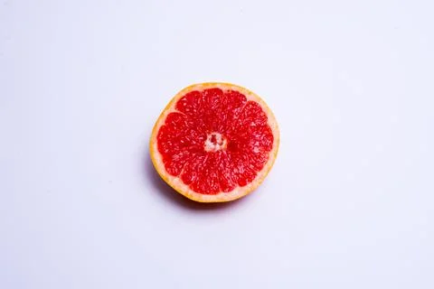 Half a fresh red grapefruit on white background Stock Photos