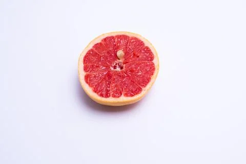 Half a fresh red grapefruit on white background Stock Photos