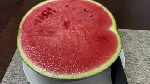 A half of fresh watermelon on the table. 4K Stock Footage 164376471