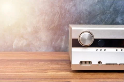 Half front side AV receiver with volume and AUX Plugin on wood table Stock Photos