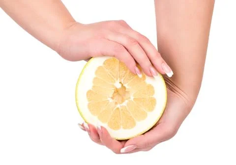 Half fruit oroblanco in hands Stock-Fotos