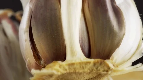 Half of Garlic bulb rustic background HD stock footage Stock Footage