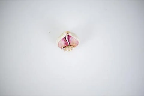 Half a garlic isolated on a white table from above Stock Photos