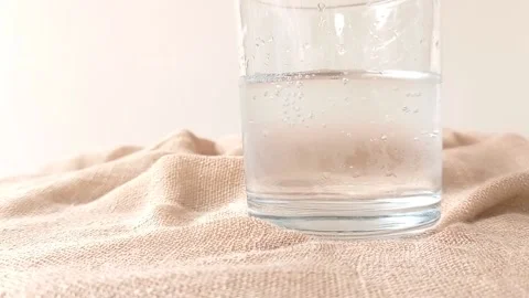 A half glass of cold water on a table Stock Footage 146249656