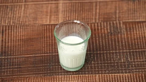 Half a glass of milk Stock Footage 183563048