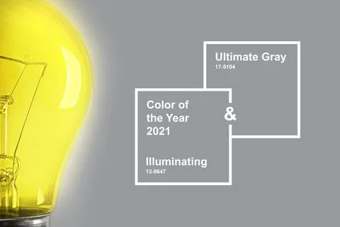 Half glowing light bulb on the gray background. Stock Photos