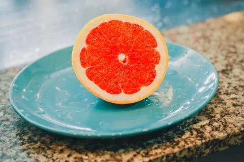 Half of grapefruit isolated on blue background Foto stock