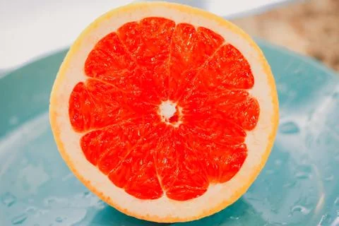 Half of grapefruit isolated on blue background Stock Photos