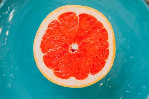 Half of grapefruit isolated on blue background Foto stock