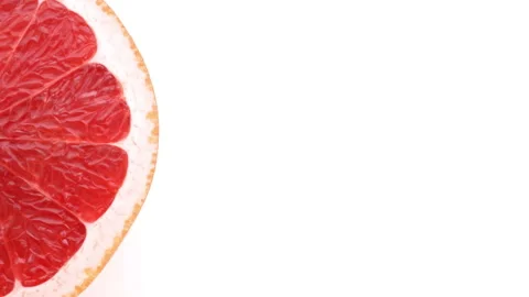 Half of grapefruit rotating on white background. Top view. Isolated. Macro. Stock Footage 158539029