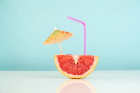 Half of grapefruit on white and blue background, vitamin cocktail concept Stock Photos