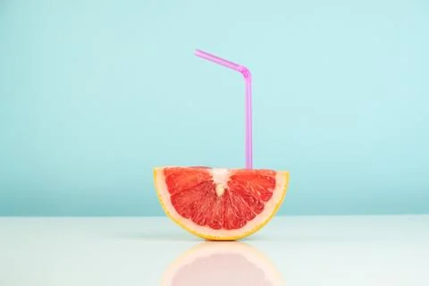 Half of grapefruit on white and blue background, vitamin cocktail concept Stock Photos