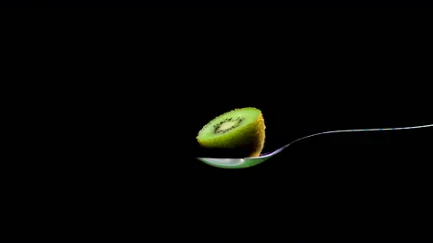 Half green kiwi close up seen sprinkled with sugar in slow motion Stock Footage 131406227