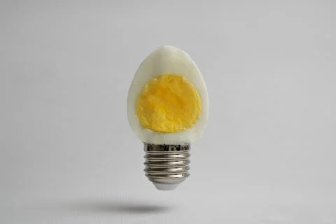 Half Hard Boiled Egg and Base Of Light Bulb Stock Photos