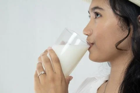 Half head photo of young asian woman drinking milk Stock Photos