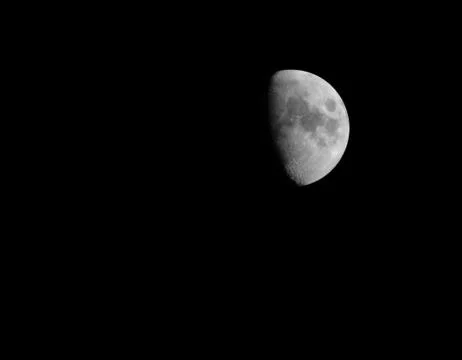Half illuminated moon Stock Photos