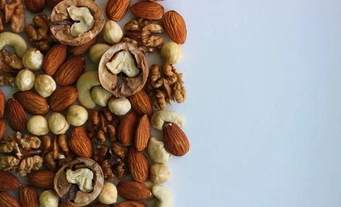 Half of the image is hidden by a mix of clean dried nuts Stock Photos