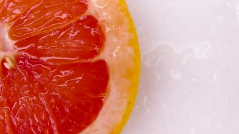 Half a juicy grapefruit on the table Stock Footage 235054324