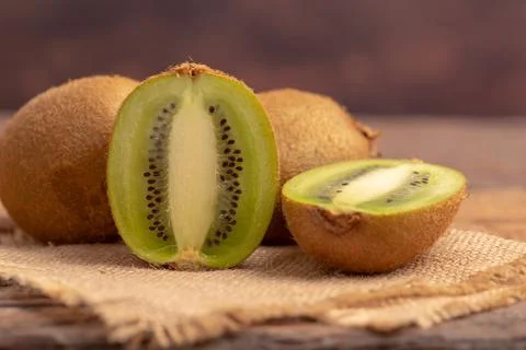 Half of the kiwi slice placed on the brown sack Stock Photos