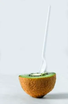 Half a kiwi with a spoon Foto stock