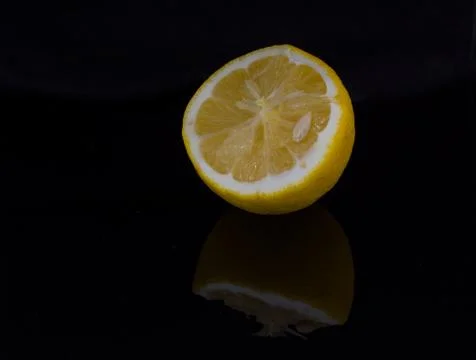 Half of a lemon on the dark background Stock Photos