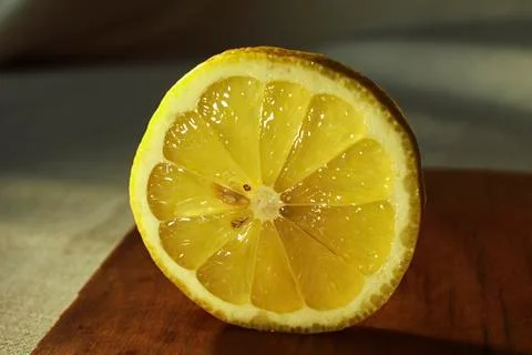 Half of lemon fruit at slice on the cutting board close up Stock Photos