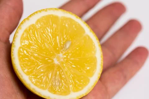 Half of a lemon in a hand Stock Photos
