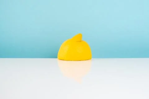 Half of lemon on white table Stock Photos